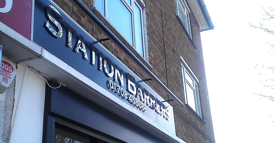 mirror finished shop name with raised back lit lettering 